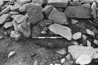 Excavation photograph : trench G - detail of hearth L275 prior to sectioning showing orthostats and base slab.

(see MS/682/120 for detailed description)