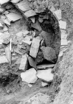 Excavation photograph :  trench R - view of collapsed cell L1933 underlying round-house wall.

