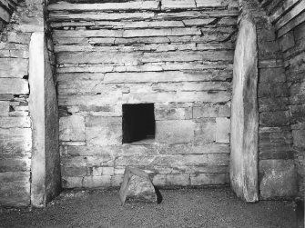 Interior of cairn; view of wall and cell.