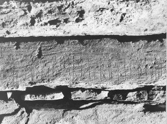 Interior of cairn; runes - on west wall above entrance.