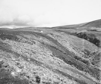 Excavation photograph : general view of Kilphedir glen with tent marking location of hut circles, and arable land.