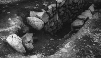 Excavation photograph : views down into souterrain.