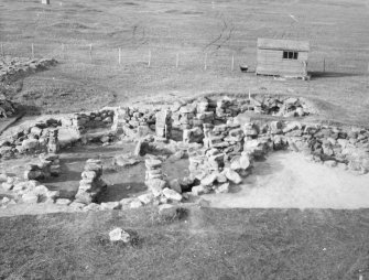 Excavation photograph : view of wheelhouses and hut, to NW.