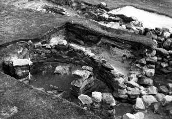 Excavation photograph : view over smaller wheelhouse, with entrance passage beyond.