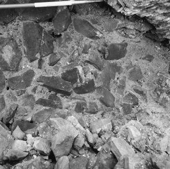 Excavation photograph showing undisturbed level in section of wall with apparent coursing
Duplicate photographic print available in MS/1179/1