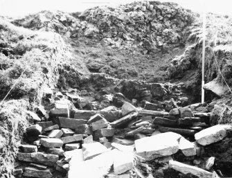 Excavation photograph showing outer face of wall at commencement of sectioning