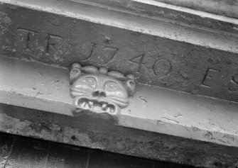 Detail of grotesque head shouldering lintel (dated 1740) above doorway, 3 High Shore, Banff.