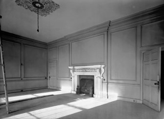 Interior view of Broxmouth Park showing panelled room with fireplace.
