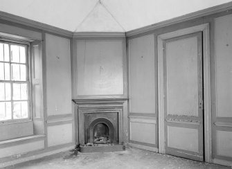 Interior view of South Lodge, Broxmouth Park, showing panelled room with fireplace.