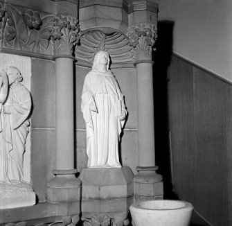 Interior view of Trinity Free Church, Irvine, showing detail of stone figure and niche.