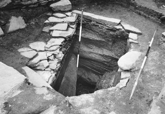 Excavation photograph : west side of well showing three rock cut steps.