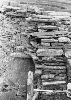 Stairs in WNW showing height of stairs above tallest orthostat, and relationship to scarcement stones. (From NE) 
Broch of Gurness, Aikerness.