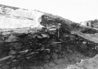 Trench 1, Area A, Extension.  Lower walls (Features 3 and 4) and midden (Feature 2) in section, Looking towards Trench 2.  From North-East.