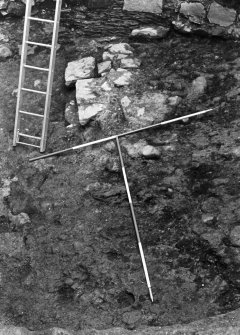 Excavation photograph : close up of wall foundations f110, from N.