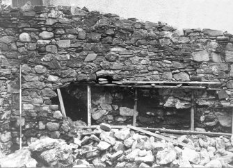 Excavation photograph : recently built masonry of S wall supported after partial collapse, from N.