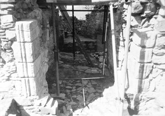 Excavation photograph : view along passage between N tower and E range, after removal of blocking, from E.