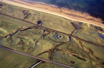 An oblique aerial view of Cinn Trolla Broch, Kintradwell, Loth, East Sutherland, looking W.