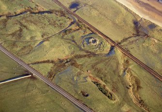 An oblique aerial view of Cinn Trolla Broch, Kintradwell, Loth, East Sutherland, looking WNW.