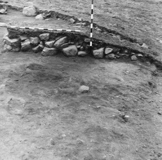 Excavation photograph  -section of cairn material showing natural slope