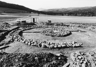 Excavation photograph : cairn, all infilling removed - ring and central cairn remaining, from east.