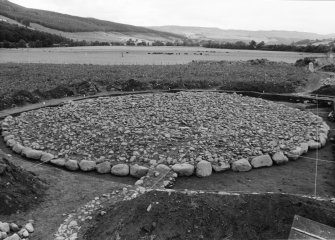 Excavation photograph : cairn cleaned to cobbled surface, from south-west.