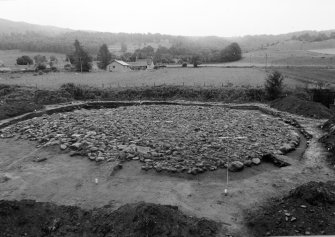 Excavation photograph : cairn cleaned to cobbled surface from north.