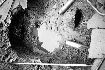 Excavation photograph : waterlogged sump after removal of infill, from south.