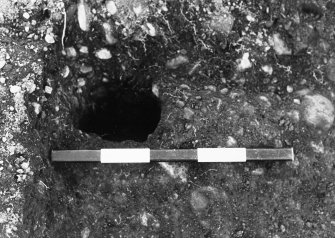 Excavation photograph : area C - posthole on western side of ditch terminal, from east.