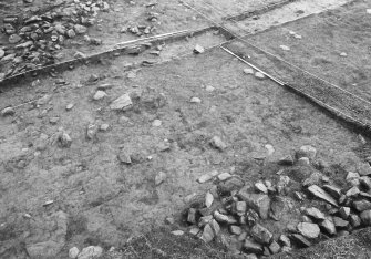 Excavation photograph : area 2 - f2004, robbed wall, N side, from NW.
