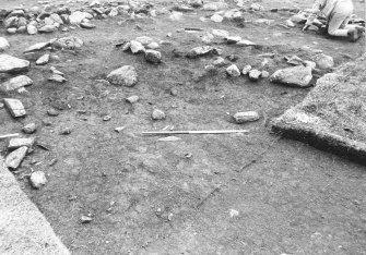 Excavation photograph : area 4 - f4011, L4015 Hut K, looking NE.
