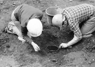 Staved wooden bowl being excavated.