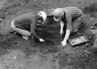 Staved wooden bowl being excavated.