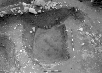 Excavation photograph : area 8 - f8075 - pit to cairn section, from west, north-west.