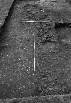 Excavation photograph : trench 2, stone spread f136 cut by trial trench.