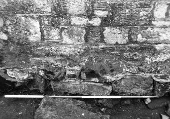 Excavation photograph : disturbance along base of wall f108, from N.