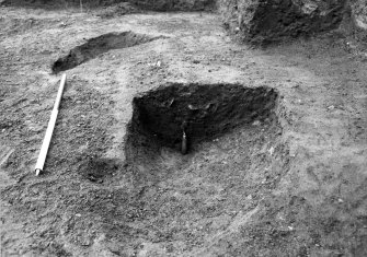 Excavation photograph : section across feature f702, from W.