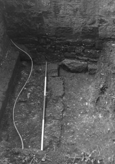 Excavation photograph : trial trench 2 - masonry wall below modern precinct wall in SE corner of garden, from S.
