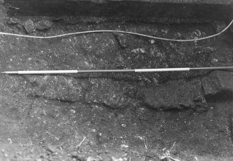 Excavation photograph : trial trench 2 - masonry wall below modern precinct wall in SE corner of garden, from W, close up.