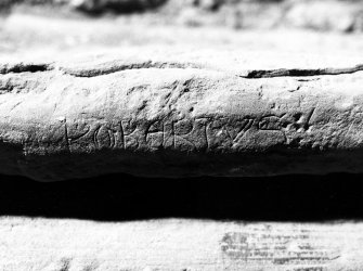 Excavation photograph : stone inscribed with 'ROBERTUS' in Lombardic capitals.