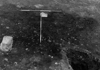 Excavation photograph. F179 pre-excavation, stone 9 to left, from south.