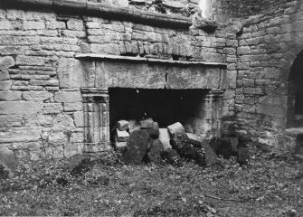 Excavation archive: Fireplace in E wall of hall at first floor level. prior to rubble clearance. From W.