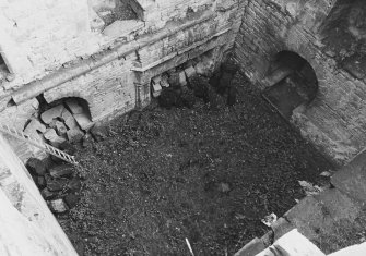 Excavation archive:Interior of tower prior to clearance of debris from first floor hall. From NW.