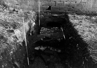 Excavation archive: Trench A, showing remnants of both cobbled surfaces, truncated by recent intrusion. From N.