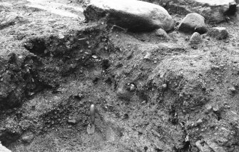 Excavation photograph : robber trench partially excavated within centre of gatehouse.