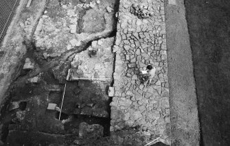 Excavation photograph : west end of gatehouse and demolished north curtain wall (from west)