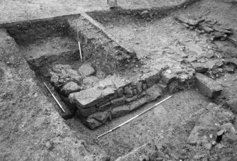 Excavation photograph : trench S, corner of building and drain, from NW.
(B&W negatives colour printed)