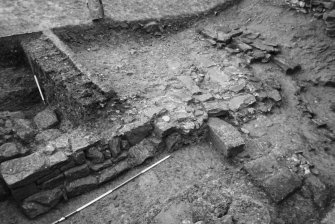 Excavation photograph : trench S, corner of building and drain, from W.
(B&W negatives colour printed)