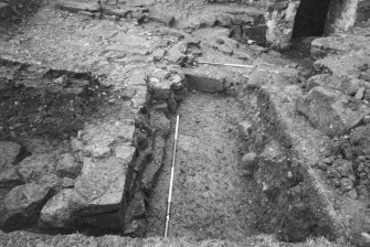 Excavation photograph : trench A, view along W wall of buidling, from N.
(B&W negatives colour printed)
