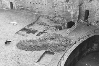 Excavation photograph : W end of courtyard showing location of trenches A and C, from N.
(B&W negatives colour printed)