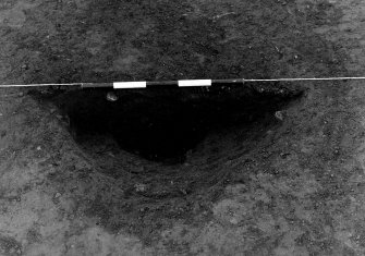 Excavation photograph : area 3 - f3046, pit half section complete, from E.